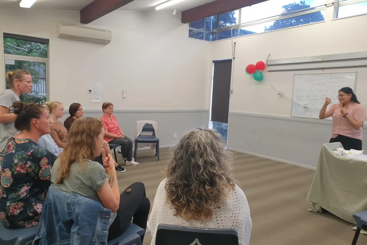 Wendy Orellana signing to a group about her lived experience as a Deaf mother, December 2024
